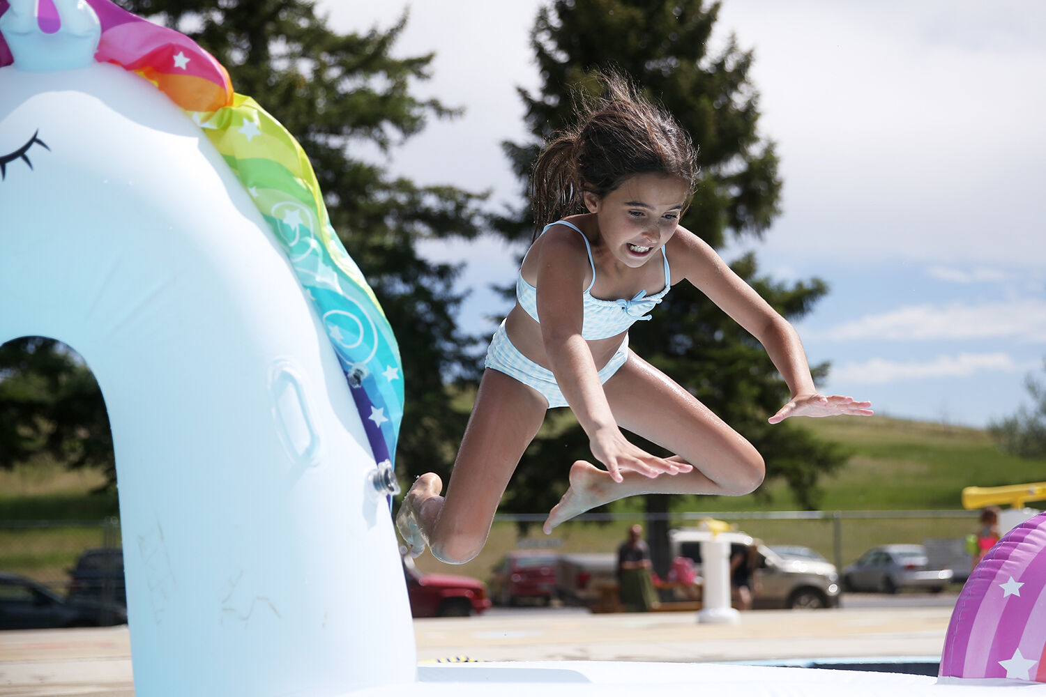 Harper Hancock, 10, leaps onto her blow up unicorn Patricia